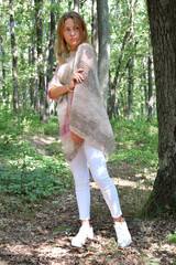 Yuomg woman in knitted poncho, Model for knitting, Handmade, Forest background