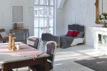 A spacious bright living room with a stylish modern design with elements of antique decor and beautiful chic furniture