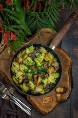 Fried potatoes with mushrooms in a pan.the view from the top.Mushroom time in autumn