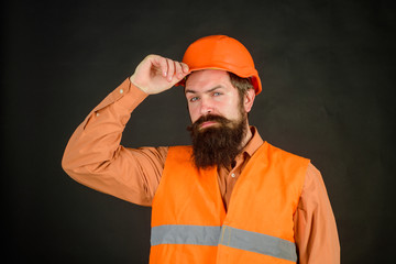 Business, building, industry, technology. Builder in hard hat. Man builder. Bearded man in overalls and construction helmet. Mechanical worker. Industrial worker. Construction worker in hardhat.