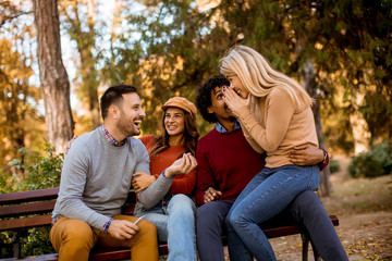 Fototapeta premium Group of young multiethnic friends having fun at park