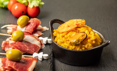 Spanish tapas, Iberian ham, Valencian paella and olives