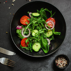 Healthy salad, leaves mix salad (mix micro greens, cucumber, tomato, onion, other ingredients). food background. copy space