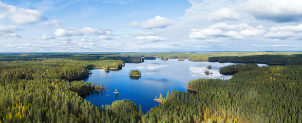 Aerial view on beautiful lake in Finland. Drone photo of Haukkajarvi lake in Helvetinjarvi National park. Lake with islands with forest and beautiful clouds in the sky.