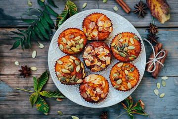 Healthy fall vegetarian dessert. Apple cupcake with pumpkin, almond seeds and spices.