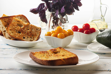 Ingredients for bruschetta with avocado, tomatoes and a basil with balsam sauce. Selective focus.