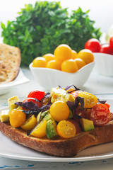 Bruschetta with avocado, tomatoes and  basil with balsam sauce. Close up. Selective focus.