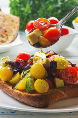 Bruschetta with avocado, tomatoes and  basil with balsam sauce. Close up. Selective focus.