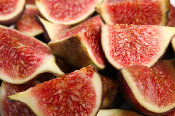 Tasty ripe cut fig fruits as background, closeup