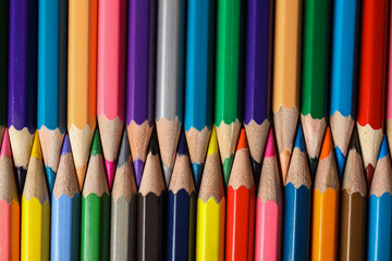 Different color pencils as background, top view
