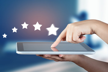 woman hand tablet with stars in screen