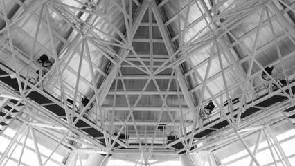 Structure of steel roof frame for building construction. Roof trusses design indoors