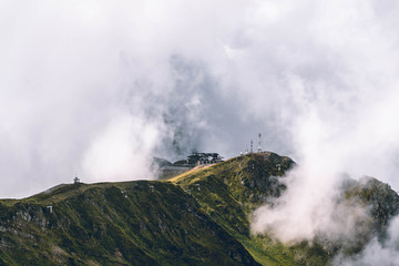 Building on the mountain covered with clouds