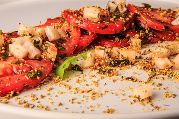 top view closeup sliced tomato decorated with assorted herbs