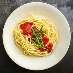 pasta spaghetti with tomato sauce (delicious gourmet dish, classic combination of taste, Italian cuisine) menu concept. food background. copy space. Top viev