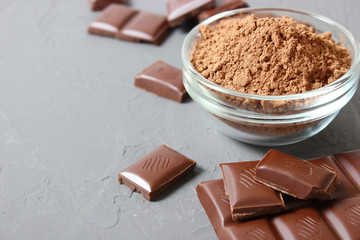 pieces of chocolate and cocoa powder on the table.