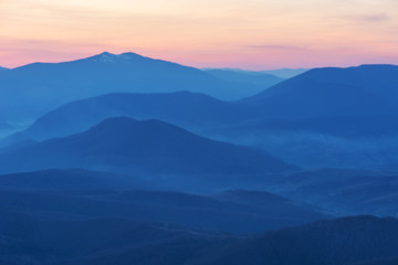 Fototapeta premium Fantastic views of the evening and morning mountain ridge with tourists and tents