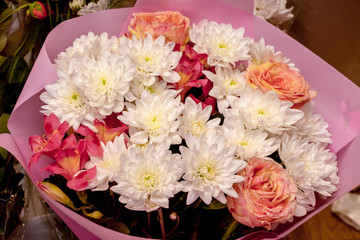 Bouquet of flowers in a wrapper of white and pink flowers_