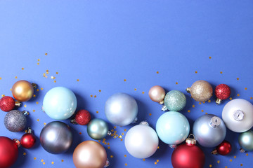 Decorative Christmas balls on a colored background top view. Place to insert text.