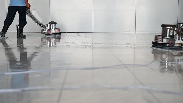 Labor cleaning the floor with cleaning machine - Slow motion