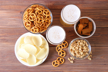 Beer and snacks on the table top view.