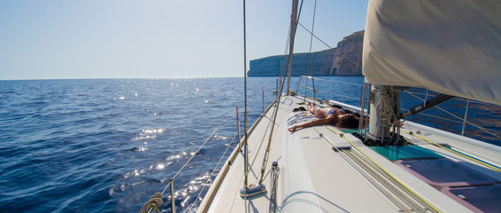 Woman relaxing on the sailing boat.