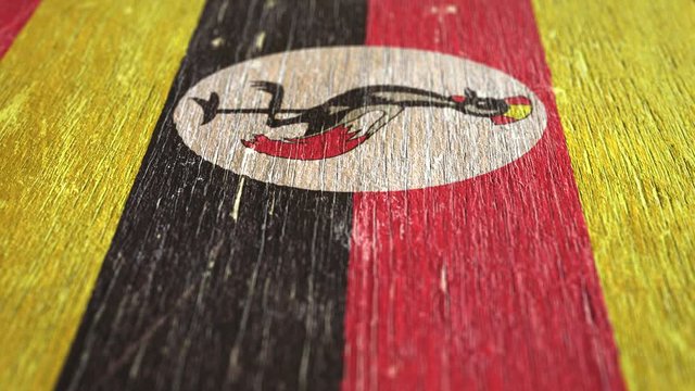 Flag Of Uganda. Detail On Wood, Shallow Depth Of Field, Seamless Loop. High-Quality Animation. Ideal For Your Country / Travel / Political Related Projects. 1080p, 60fps.