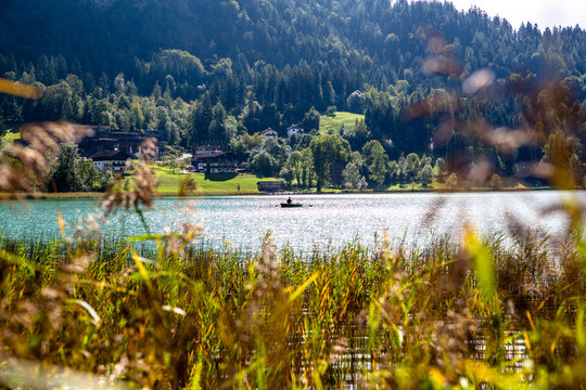The mountain lake Thiersee in Tyrol, Austria. Boat with Fisherman on lake.