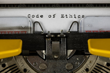 old typewriter with text code of ethics