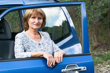 Attractive senior lady traveling with automobile. Active lifestyle concept