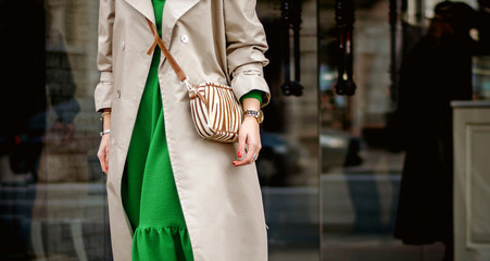 Fashionable bag close-up in female hands.Girl walks in the city outdoors. Stylish modern and...