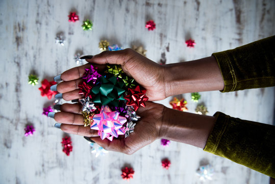 hands holding holiday bows