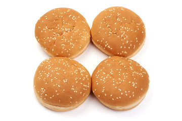 Delicious burger buns with sesame seeds, ingredients for burger, isolated on white background