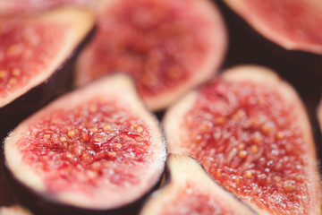 Fresh sliced figs on table closeup. Top view. Selective focus.