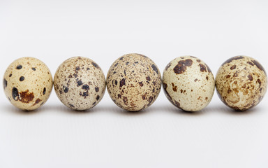 Quail eggs on white background. Free copy space.