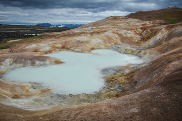 Leirhnjukur, Krafla fires  in Iceland, blue water on clay hill, overcast day in summer, film effect with grain