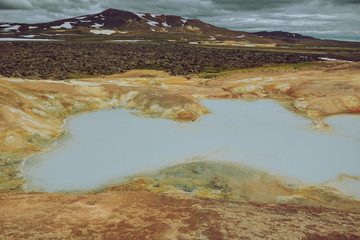 Leirhnjukur, Krafla fires  in Iceland, blue water on clay hill, overcast day in summer, film effect with grain