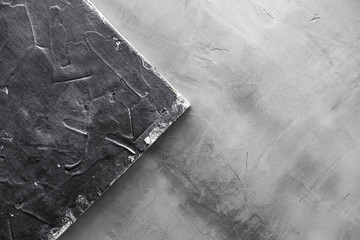 wooden background covered with putty on the background of cement-concrete wall