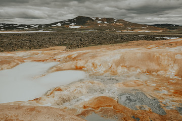 Leirhnjukur, Krafla fires  in Iceland, blue water on vlay hill, overcast day in summer, film effect...