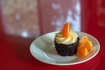 Chocolate muffin with creme and orange