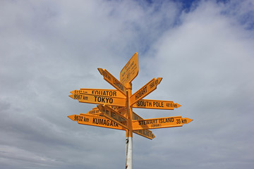 Signpost in Bluff, the southernmost point of new zealand, showing towards other cities of the world