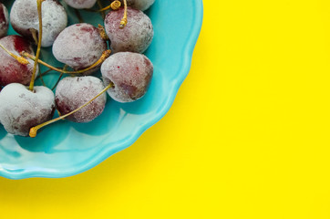 cherry berries cherries frozen by frost on a bright background