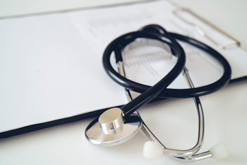 Stethoscope with prescription clipboard, Healthcare and medical concept, test results in background,selective focus