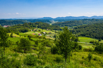 Fototapeta na wymiar Aerial view of green hills and nature in Zagorje, northern Croatia on sunny summer day