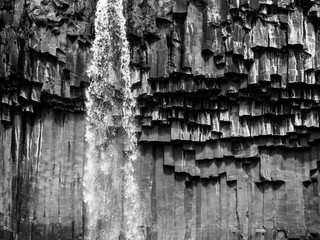 Waterfall cascading over basalt columns in Iceland