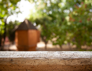 .image of wooden table in front of abstract blurred background of