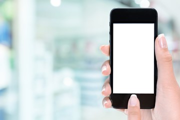 Hand holding smartphone  on blurred city background, bokeh