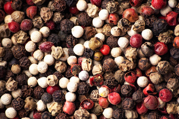 Multi-colored pepper seeds close-up. Occupy the frame completely. Selective focus. Seasoning and cooking.