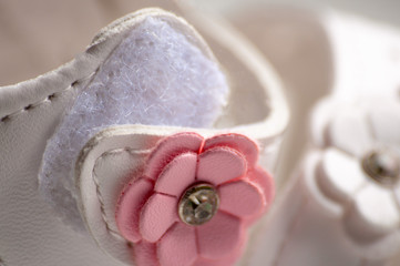 Velcro on children's shoes close-up. White shoes with a pink flower. Safety and comfort.