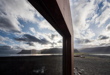 Sunset reflected in the glass of a home in the Westfjords